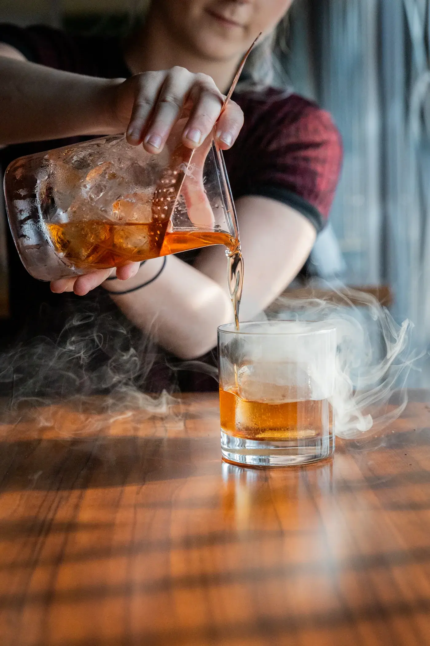 Khom Fai craft cocktail in warm bar light